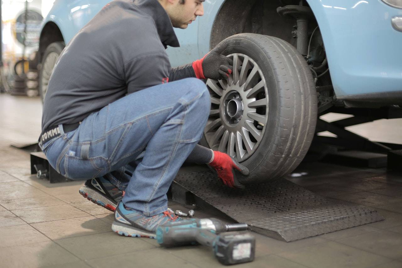 A man changing tyre - darren yaw singapore